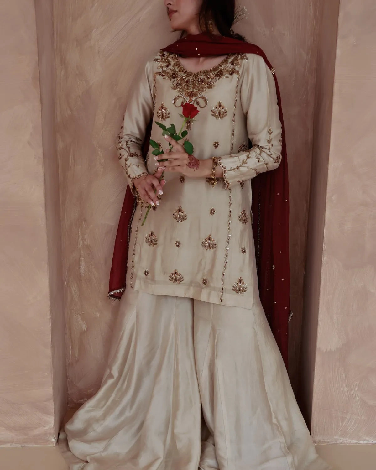 Traditional outfit with intricate embroidery against a plain background
