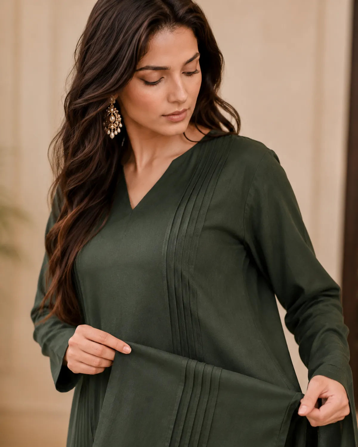 Woman wearing a green dress with a neutral background